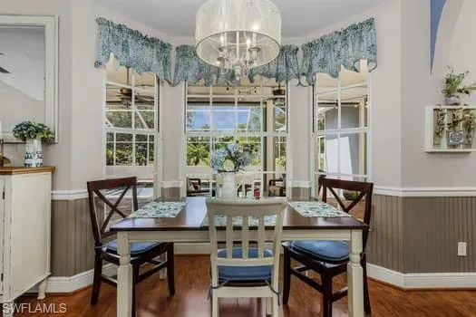 Kitchen featuring white cabinetry, dark countertops, appliances with stainless steel finishes, and lofted ceiling