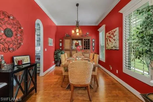 Doorway to property featuring covered porch and ceiling fan