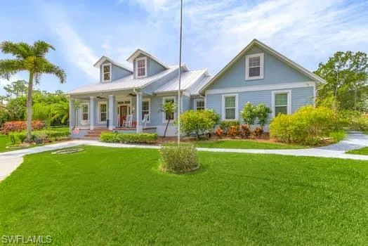 Cape cod house with covered porch and a front yard
