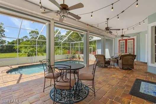 Outdoor pool featuring a lanai, area for grilling, and a patio area
