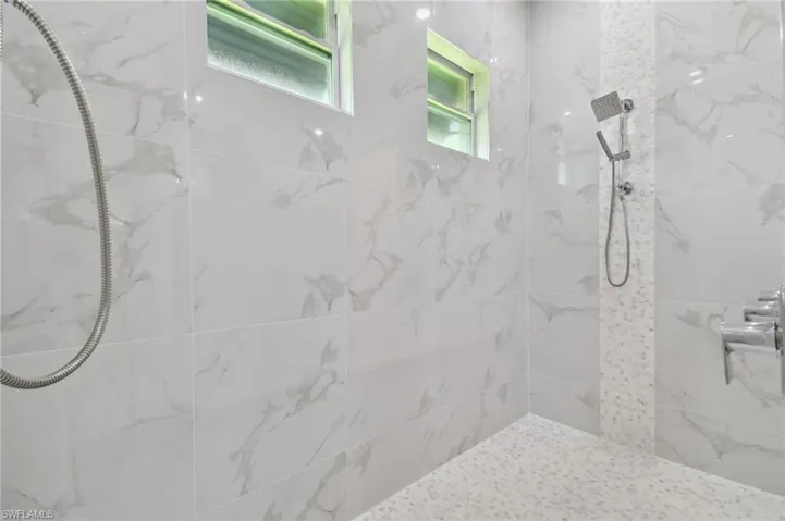 Bathroom featuring tiled shower