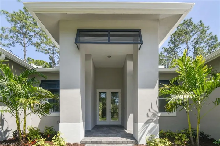 Property entrance featuring french doors