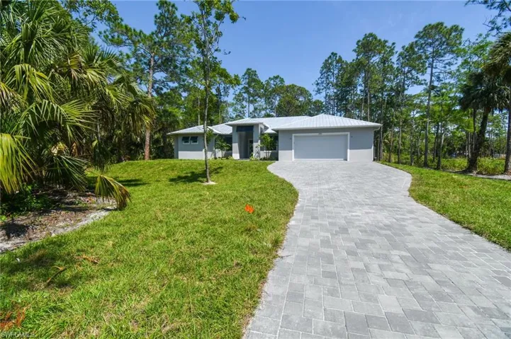 Ranch-style home with a garage and a front yard