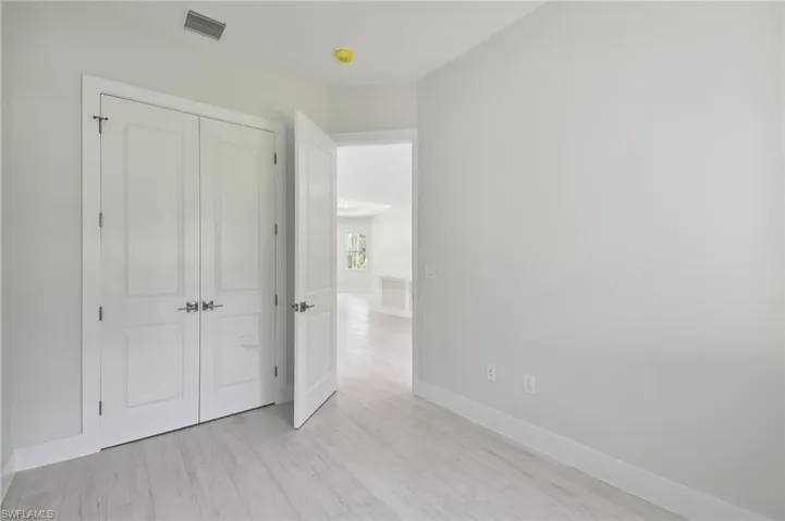Unfurnished bedroom featuring light hardwood / wood-style floors and a closet