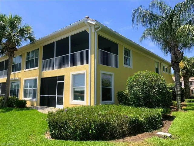 Rear view of property featuring a lawn