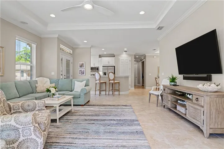 Living area featuring ceiling fan, recessed lighting, and crown molding