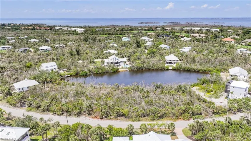 Aerial perspective of suburban area with a large body of water