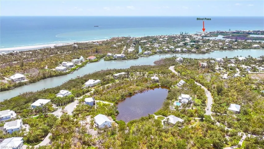Aerial view of property and surrounding area with a nearby body of water and nearby suburban area