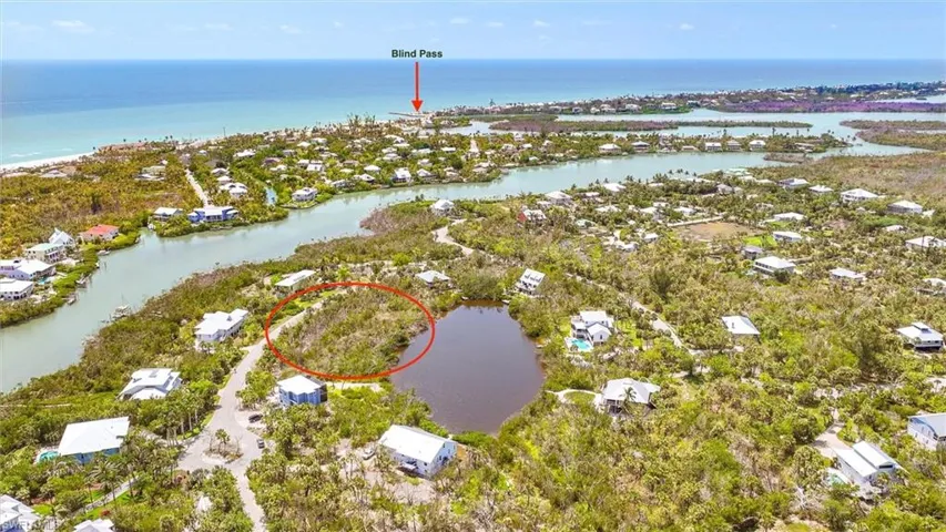Aerial overview of property's location featuring a nearby body of water and nearby suburban area