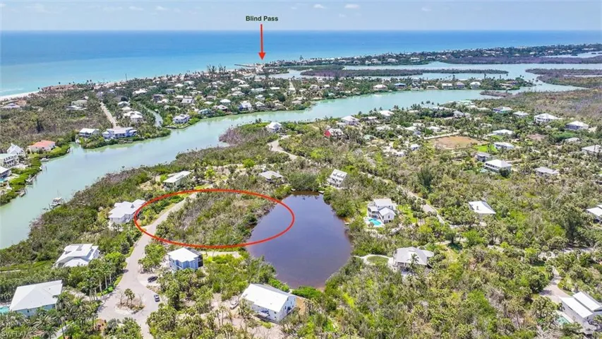 View of property location featuring a large body of water and nearby suburban area