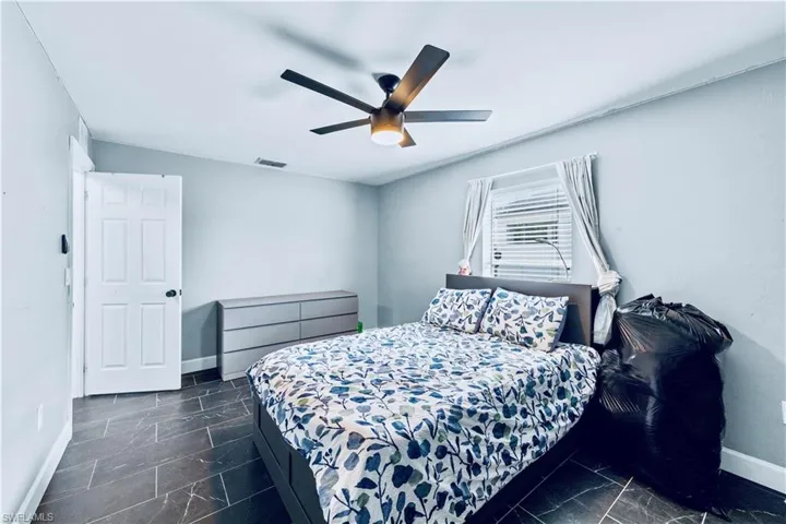 Bedroom featuring visible vents, baseboards, and ceiling fan