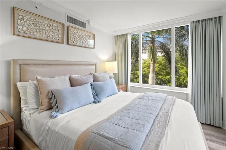 Bedroom featuring crown molding and wood finished floors