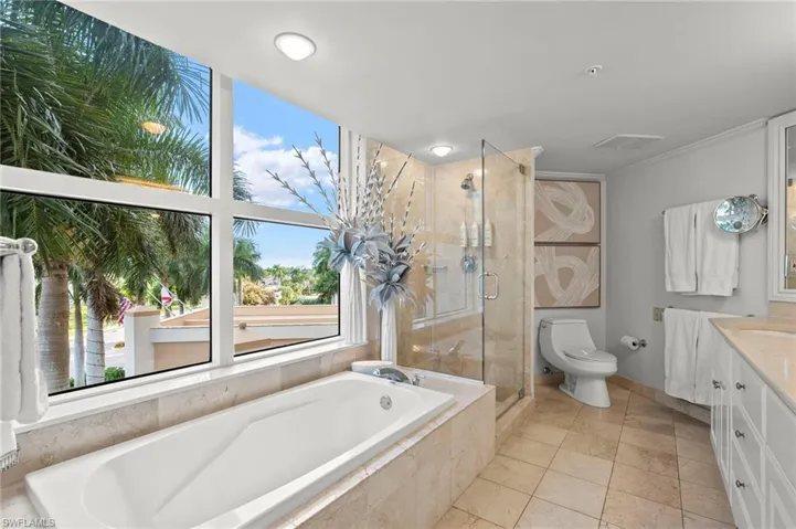 Primary ensuite bath with soaking tub, separate shower and oversized double bowl vanity.