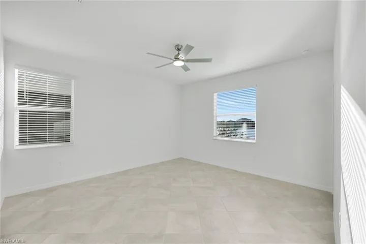 Corridor featuring recessed lighting and light tile patterned flooring