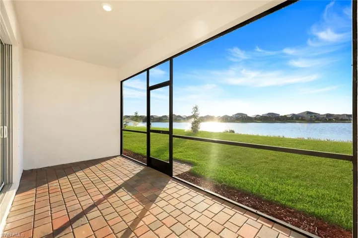 Unfurnished sunroom with a water view