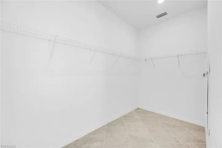 Spare room featuring a ceiling fan and light tile patterned flooring