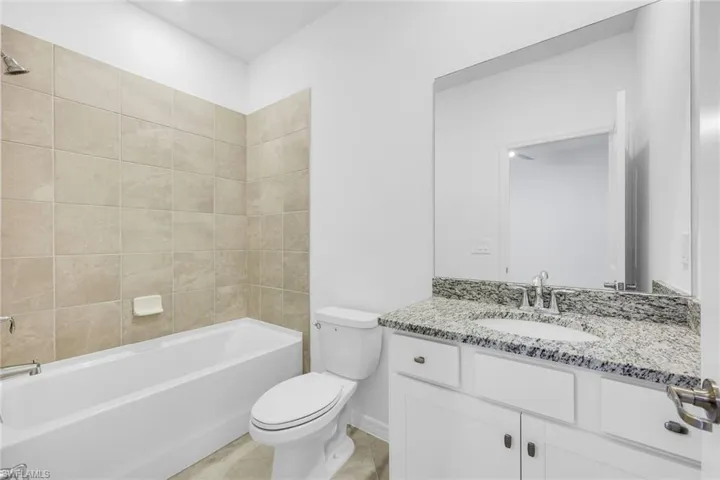 Unfurnished room featuring baseboards and ceiling fan
