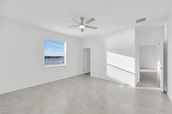Spare room featuring baseboards and ceiling fan
