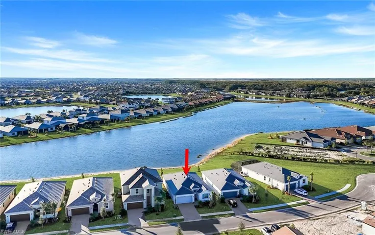 Aerial perspective of suburban area featuring a large body of water
