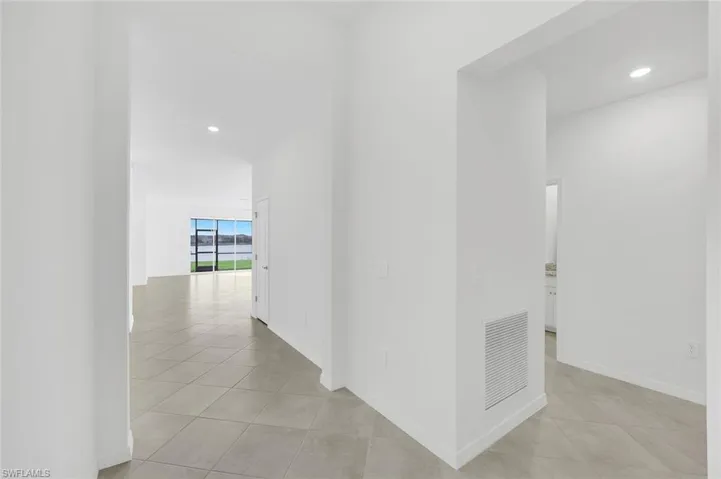 Kitchen featuring white cabinets, decorative light fixtures, open floor plan, stainless steel dishwasher, and recessed lighting