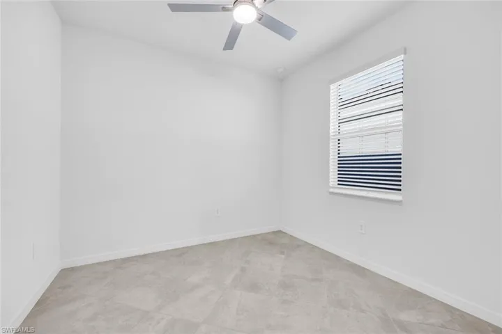 Bathroom with vanity, shower / tub combination, and light tile patterned floors