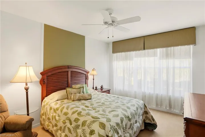 Bedroom featuring light colored carpet and ceiling fan