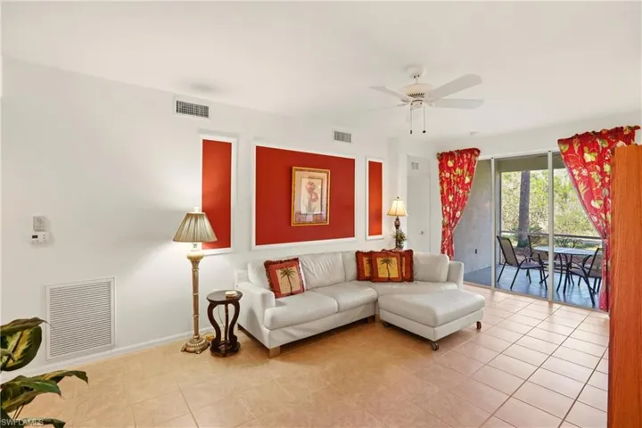 Living area featuring light tile patterned flooring and a ceiling fan