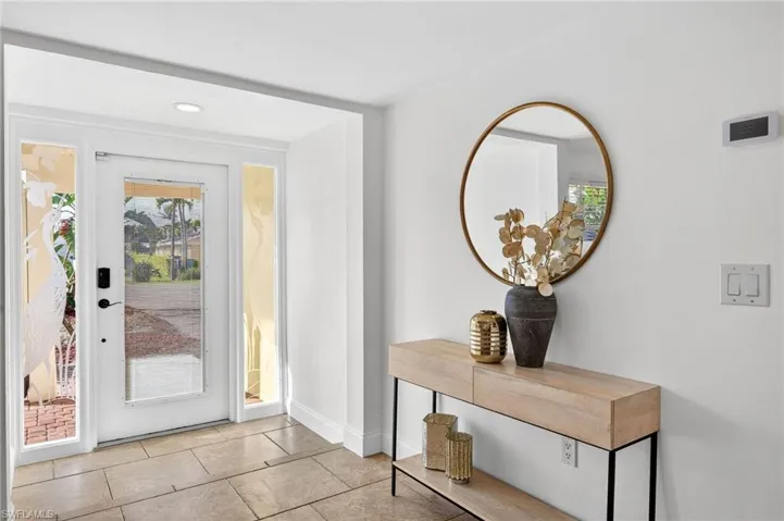 Doorway to outside featuring tile patterned flooring and recessed lighting