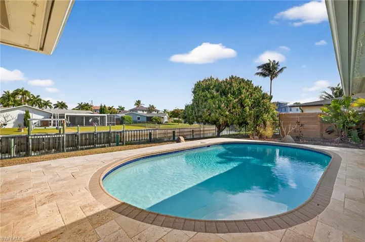 View of pool with a fenced backyard, patio surround, and a residential view