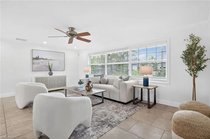 Living area featuring a ceiling fan, crown molding, and recessed lighting