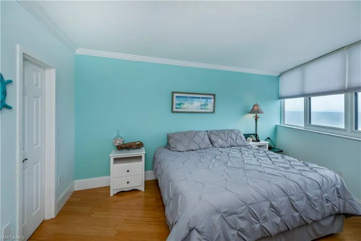 bedroom 2 features large walk in, suspended tv and coastal accents