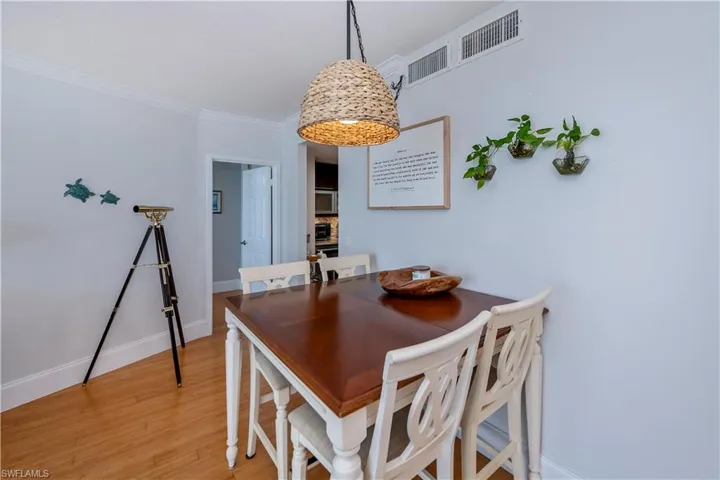 Dining space featuring light hardwood / wood-style flooring and crown molding