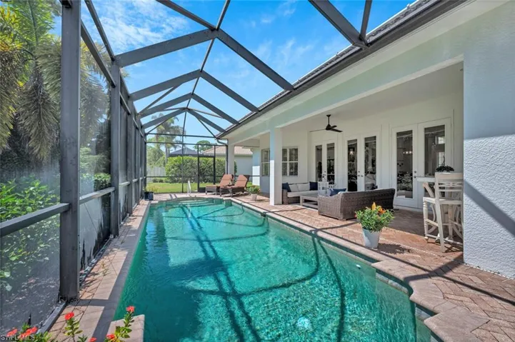 View of pool with an outdoor living space, french doors, a fenced in pool, a ceiling fan, and a patio