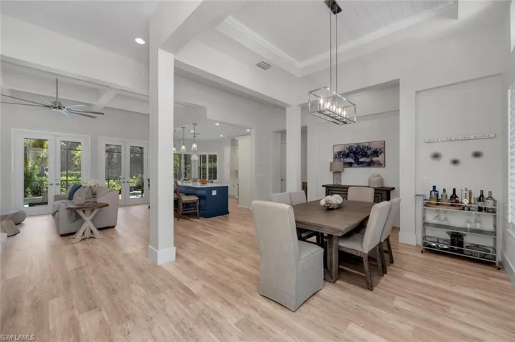 Dining room featuring visible vents, french doors, beam ceiling, and light wood finished floors