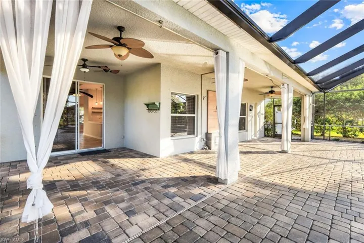 View of patio / terrace featuring a lanai and a ceiling fan