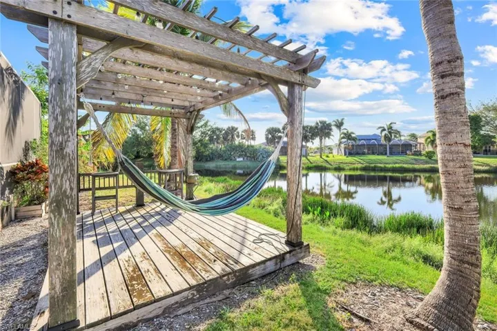 Wooden terrace with a pergola and a water view
