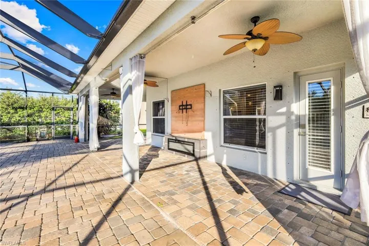 View of patio / terrace with a lanai and a ceiling fan