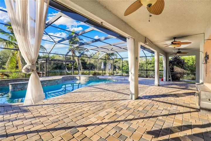 Pool featuring ceiling fan, a patio, and a lanai
