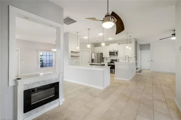 Kitchen with a peninsula, stainless steel appliances, and a ceiling fan