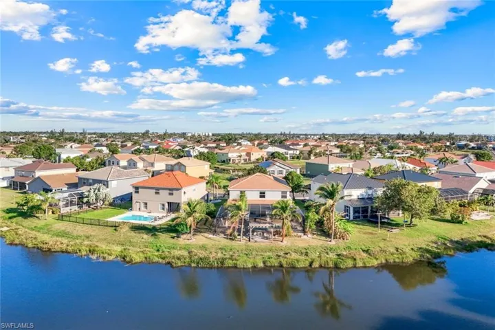 Drone / aerial view with a residential view and a water view
