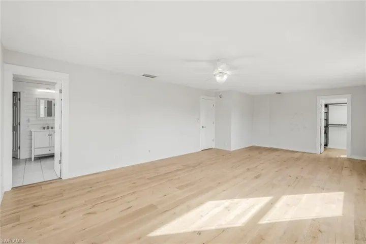 Unfurnished room featuring visible vents, baseboards, light wood-style flooring, and a ceiling fan