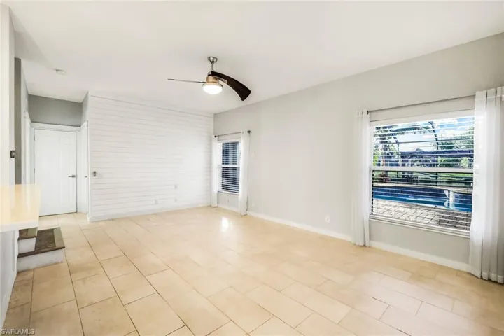 Spare room with baseboards and ceiling fan