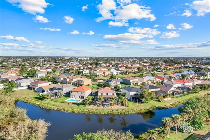 Aerial view featuring a residential view and a water view