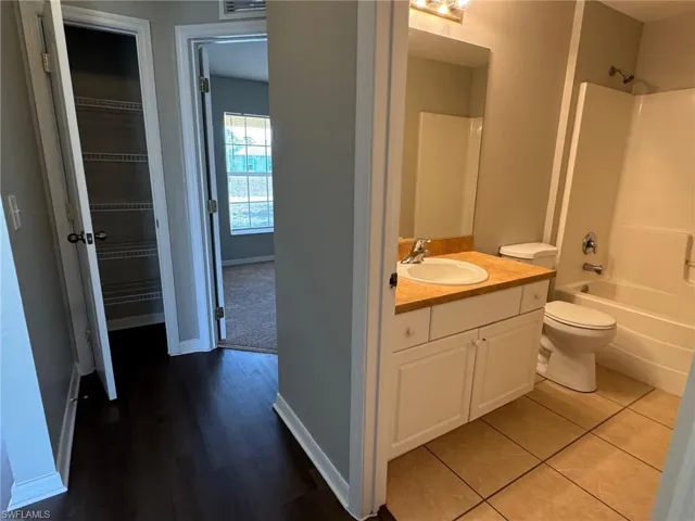 Bathroom featuring vanity, shower / washtub combination, and light tile patterned floors
