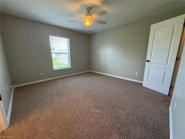 Unfurnished room with carpet flooring and a ceiling fan