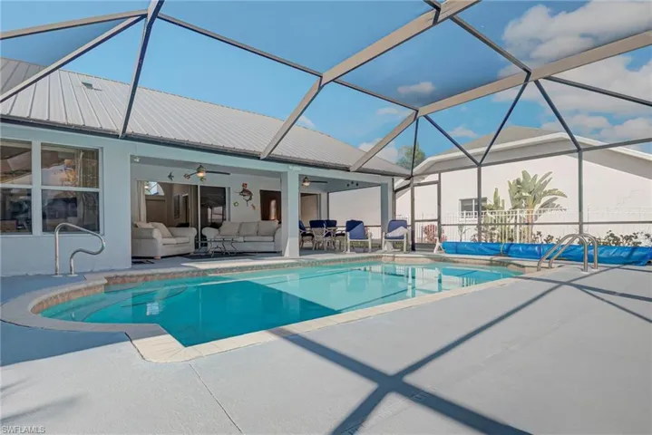 Swimming pool featuring an outdoor hangout area, a lanai, a patio, and a sunroom