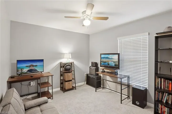 Office area featuring carpet floors and a ceiling fan