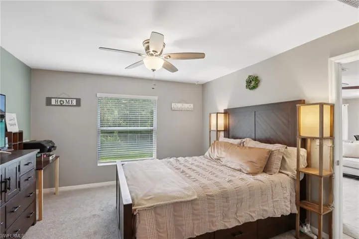 Bedroom featuring light carpet and ceiling fan