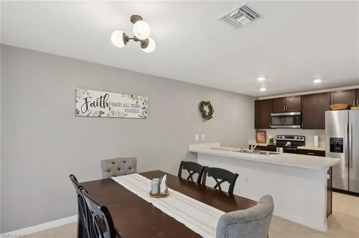 Dining room featuring light tile patterned flooring and recessed lighting
