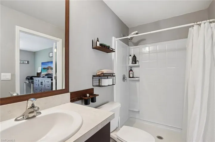 Full bath with vanity and tiled shower